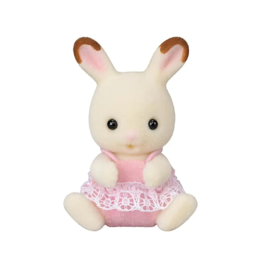 Calico Critters Chocolate Rabbit Twin has cream flocked fur, brown-tipped pink ears, black eyes, and a soft pink outfit with white lace trim, seated on white.