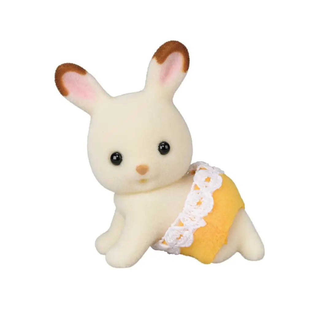 Calico Critters Chocolate Rabbit Twin has cream flocked fur, brown-tipped pink ears, black eyes, and yellow fabric bottoms with white lace trim, posed crawling.