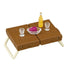 Calico Critters picnic table uses a brown plastic suitcase with cream folding legs, topped with clear goblets, purple grapes, and a yellow drink bottle on white.