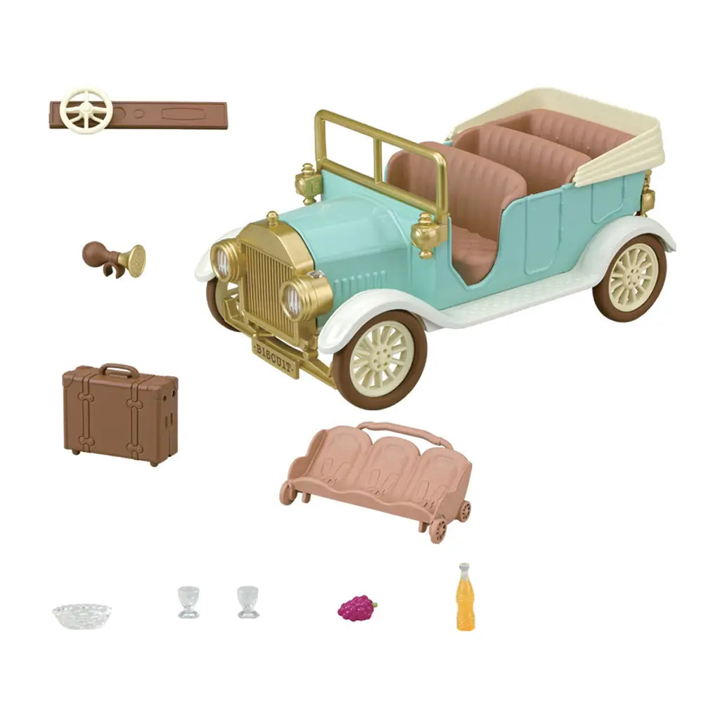 Calico Critters Classic Family Car set includes a mint and gold convertible, tan bench seat, brown suitcase, steering part, horn, clear glasses, grapes, and drink.
