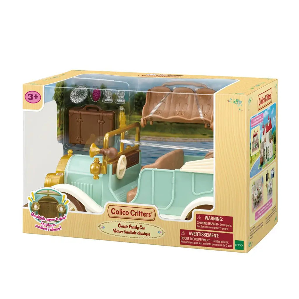 Calico Critters Classic Family Car boxed playset displays a mint convertible with gold trim and tan seats, plus a brown suitcase, bench, drink, glasses, and grapes.