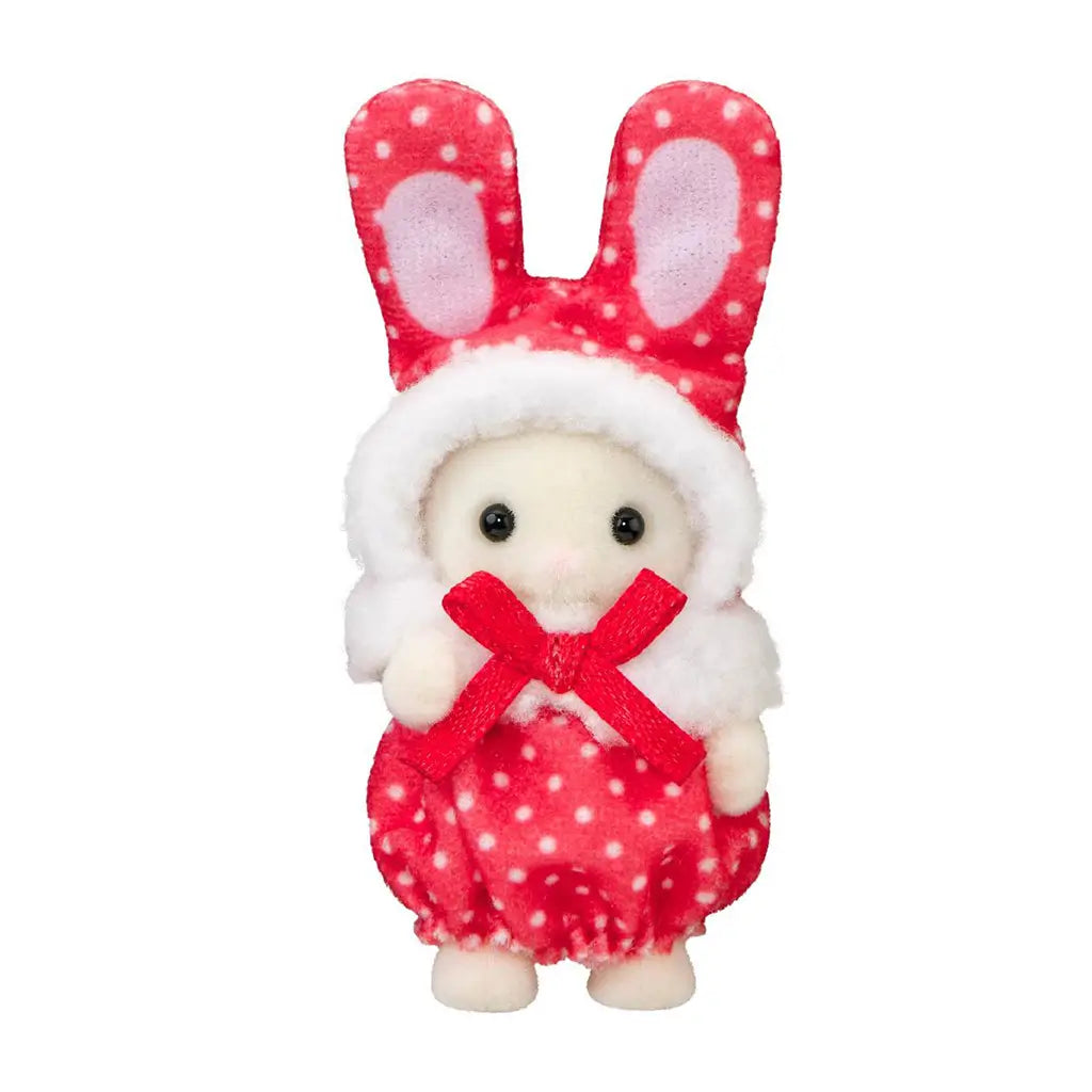 Calico Critters baby figure wears a red polka-dot plush bunny costume with tall ears, white fuzzy hood trim, and a red satin bow, posed against a white background.