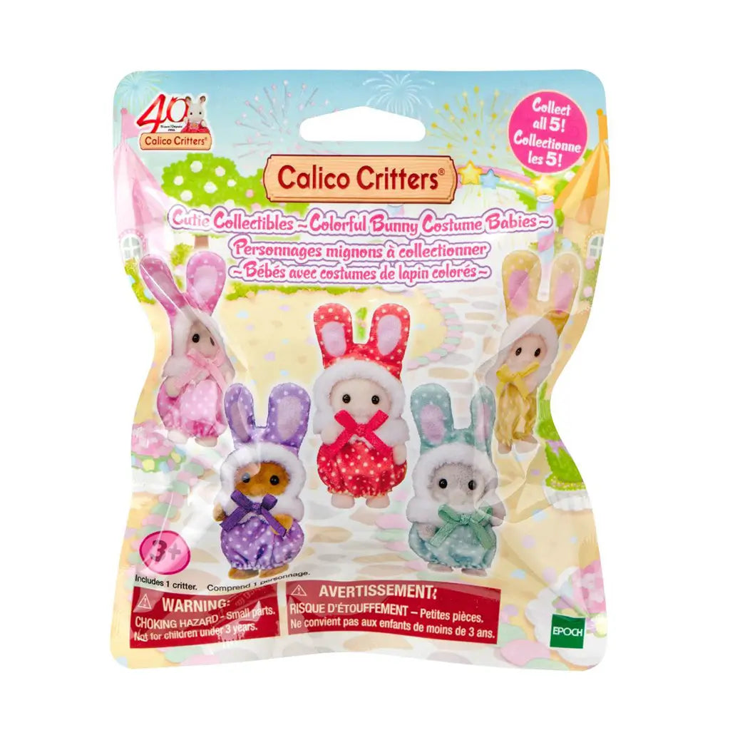 Calico Critters Cutie Collectibles blind box has pastel paper packaging showing five colorful bunny costume babies, with a collect-all-five message and age 3+ warning.