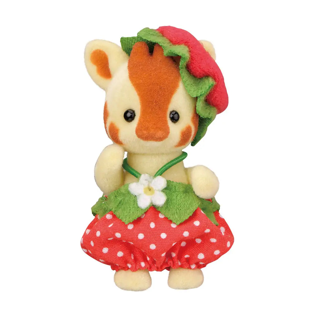 Calico Critters Very Berry Babies giraffe figure in yellow flocked texture with orange markings, small ossicones, and calm expression, dressed in a red polka-dot strawberry skirt with green leaf accents.