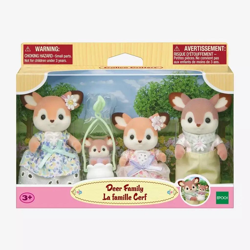 Calico Critters Deer Family toy set in retail packaging, featuring four flocked brown and cream deer figurines with pastel floral outfits against a scenic garden backdrop.