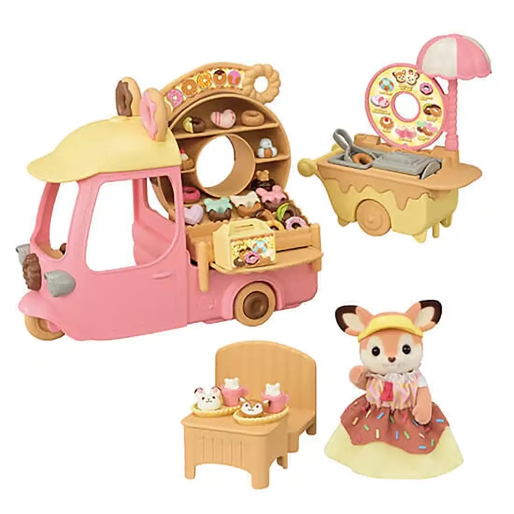 Calico Critters Dip Dip Donuts playset includes a pink truck with chocolate donut sign, fryer cart, fox figure, and display shelves filled with colorful toy donuts and pastries.