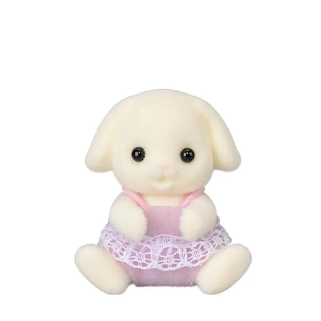 Calico Critters Flora Rabbit twin has cream flocked fur, black eyes and floppy ears, wearing a pink romper with white lace trim while seated on a white background.