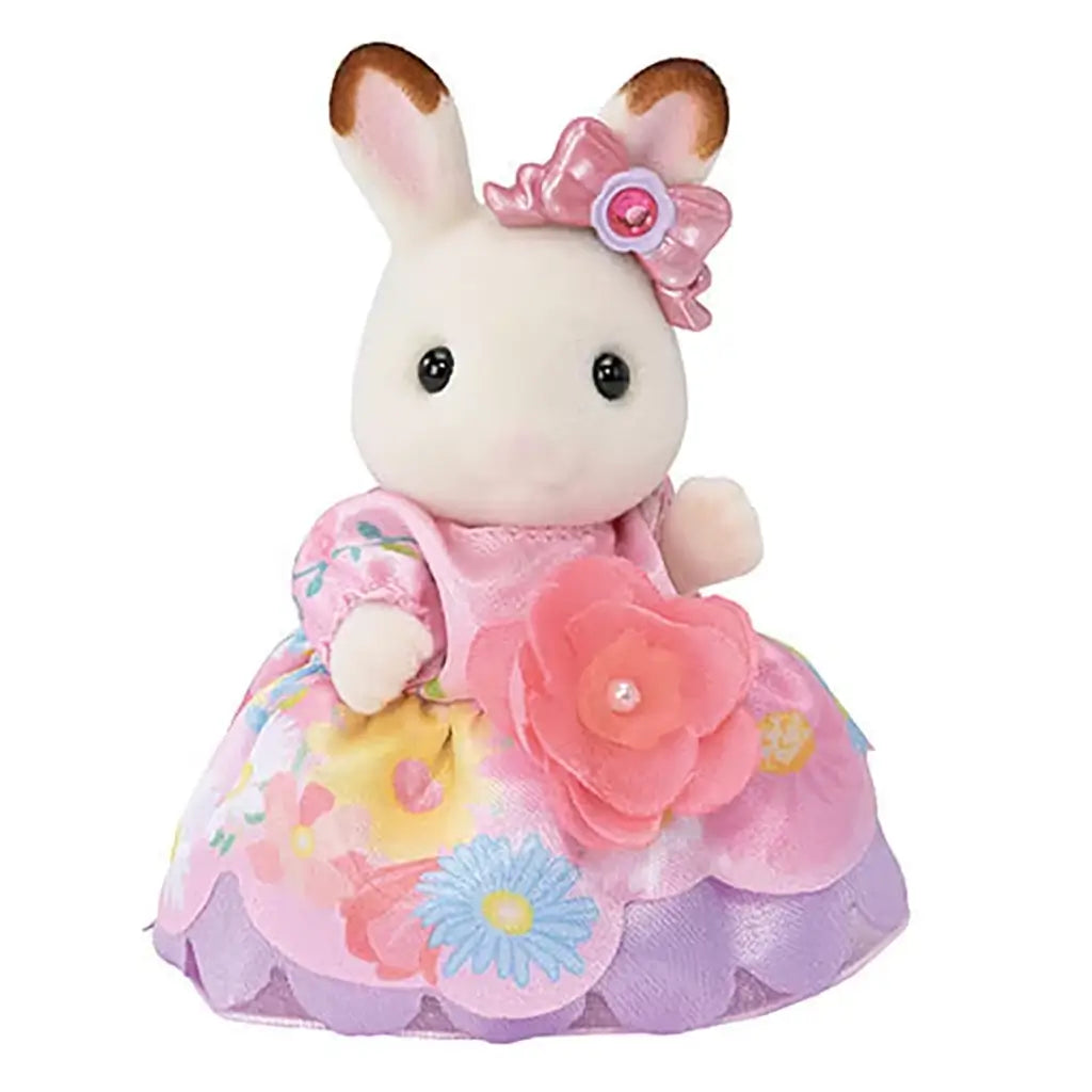 Calico Critters Chocolate Rabbit Girl is dressed in a pink and yellow floral princess gown with a large rose bow and matching hair accessory on her ear.
