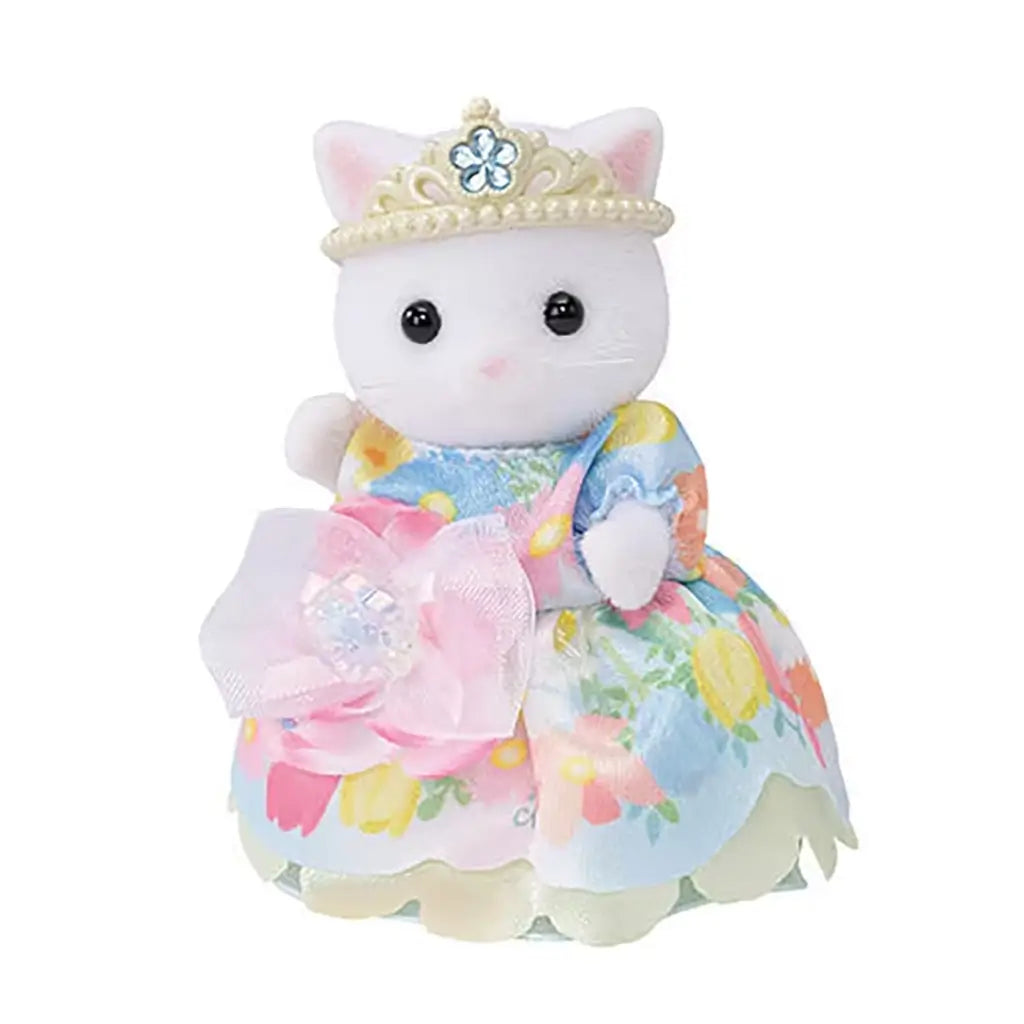 Calico Critters Persian Cat Girl figure wears a blue and floral pastel princess gown with a pearl tiara and pink flower bow, posed against a white background.