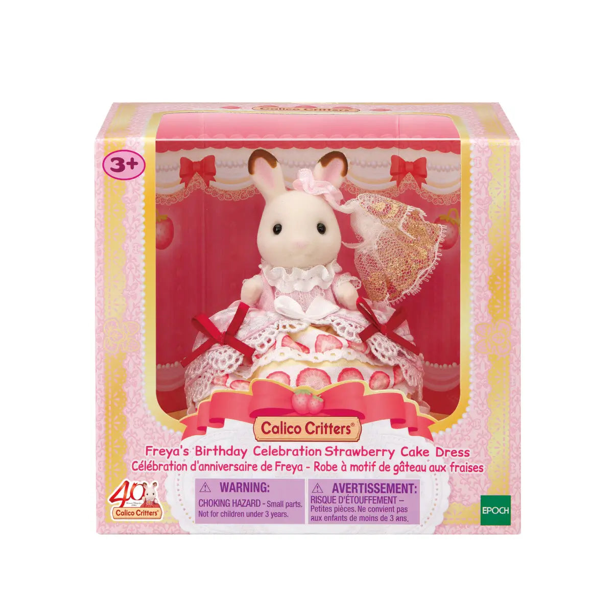 Calico Critters Freya Strawberry Cake Dress set features pink and yellow box packaging with white rabbit figure in lace trimmed strawberry print gown and parasol displayed in window front.