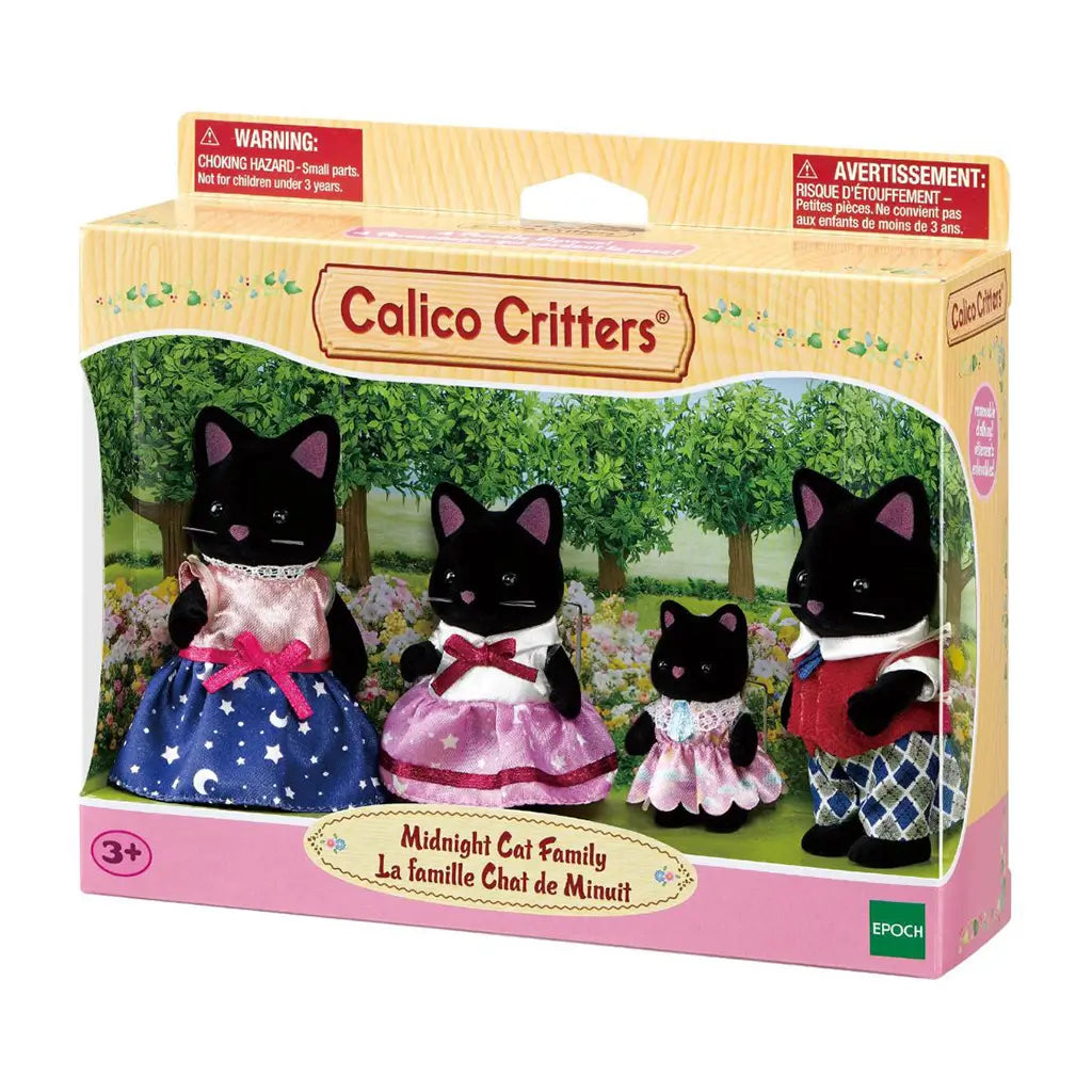 Calico Critters Midnight Cat Family package displays four black flocked cat figures in colorful dresses and formal clothes inside a windowed box with a garden scene.