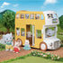 Calico Critters Nursery Double Decker Bus in yellow and white carrying multiple animal figures including rabbits, elephants, and bears, set in a grassy outdoor scene with trees and mountains in the background.