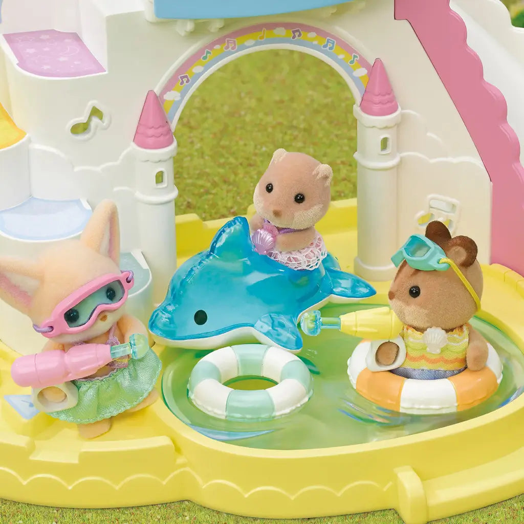 Calico Critters Pool Fun Trio figures enjoy water play in a yellow castle pool with goggles, blasters, floats, and a dolphin float while splashing in a playset scene.
