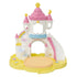 Calico Critters nursery castle playset assembled with round stage platform attached, showing pastel pink turrets, rainbow accents, slide, and yellow base.