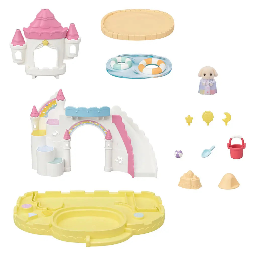 Calico Critters Nursery Sandbox & Pool accessories laid out with pastel castle parts, sandbox, pool with floats, sand bucket, ball, sand molds, and baby puppy figure.