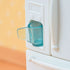Calico Critters refrigerator water dispenser features white molded plastic door with clear aqua cup inserted in built in ice and water slot against soft orange background.