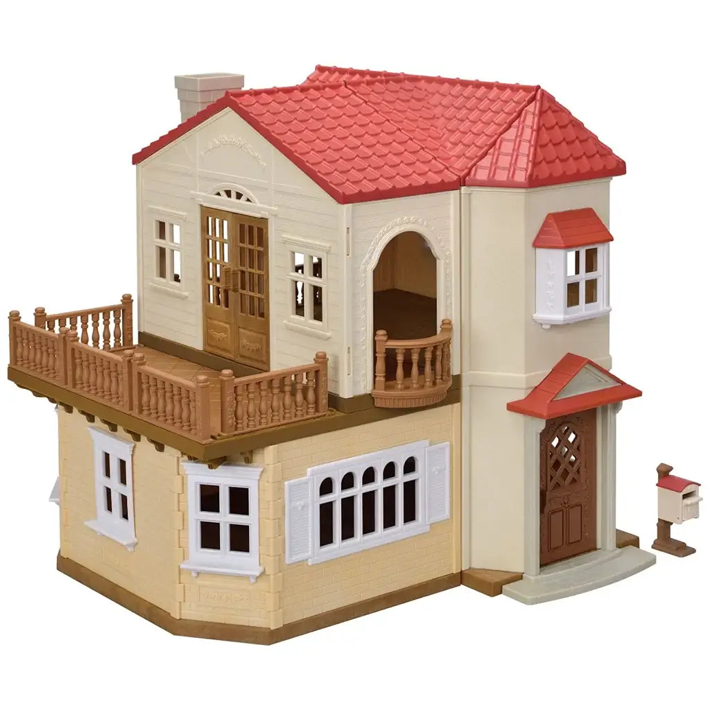Calico Critters Red Roof Country Home toy dollhouse with cream walls, red shingle roof, brown railings, and detailed windows, designed for imaginative play and miniature figures.
