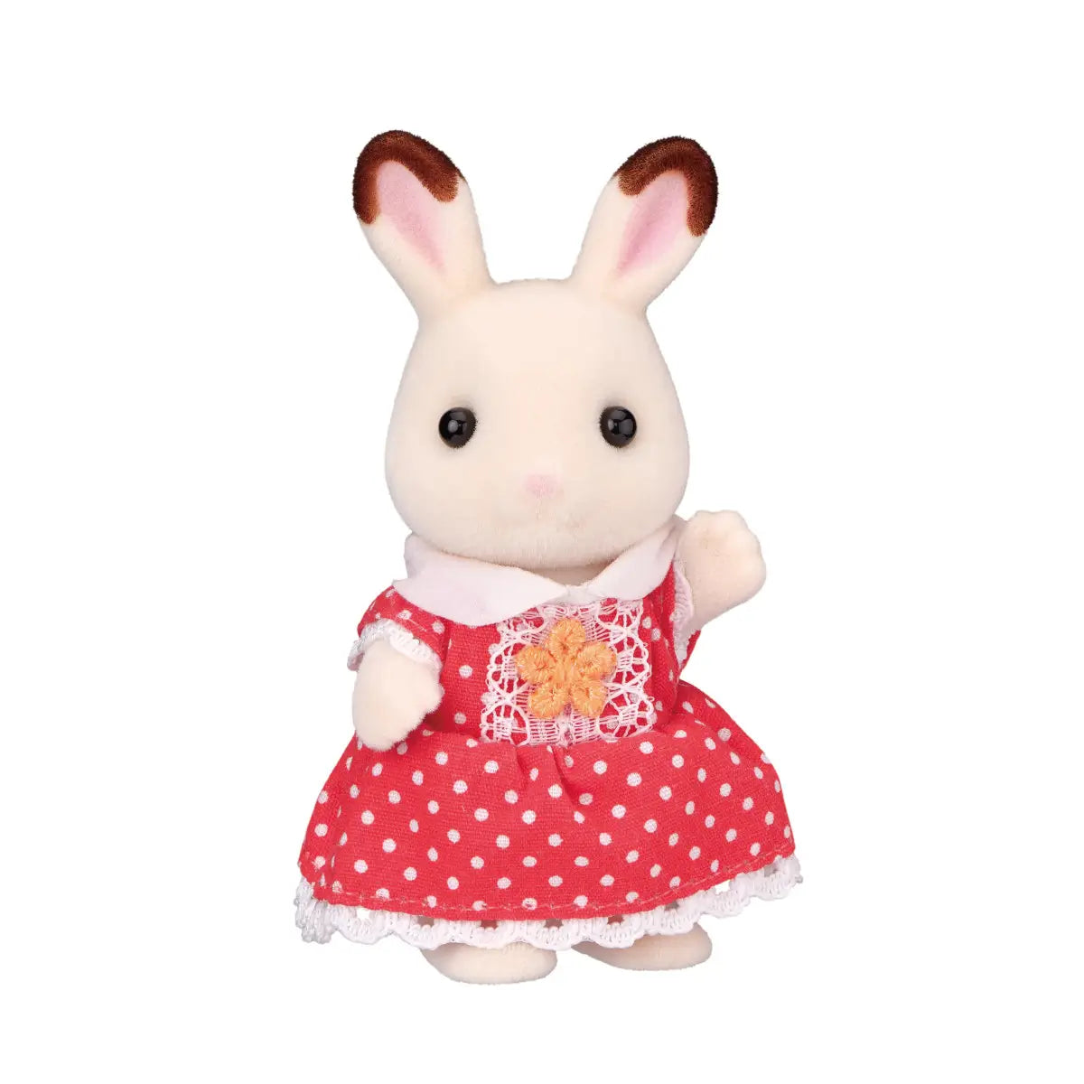Calico Critters Chocolate Rabbit Girl figure with cream-colored fur, brown-tipped ears, and red polka-dot dress accented by lace and an orange flower, standing upright on a white background.