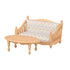 Tan miniature wooden-style sofa and oval coffee table with pink, green, and white patterned cushions, crafted as part of a Calico Critters dollhouse furniture living room set.
