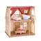 Two-story Calico Critters Red Roof Cozy Cottage dollhouse with red roof, beige walls, wooden floors, and miniature furniture including bed, bathtub, and sofa, featuring a rabbit doll inside.