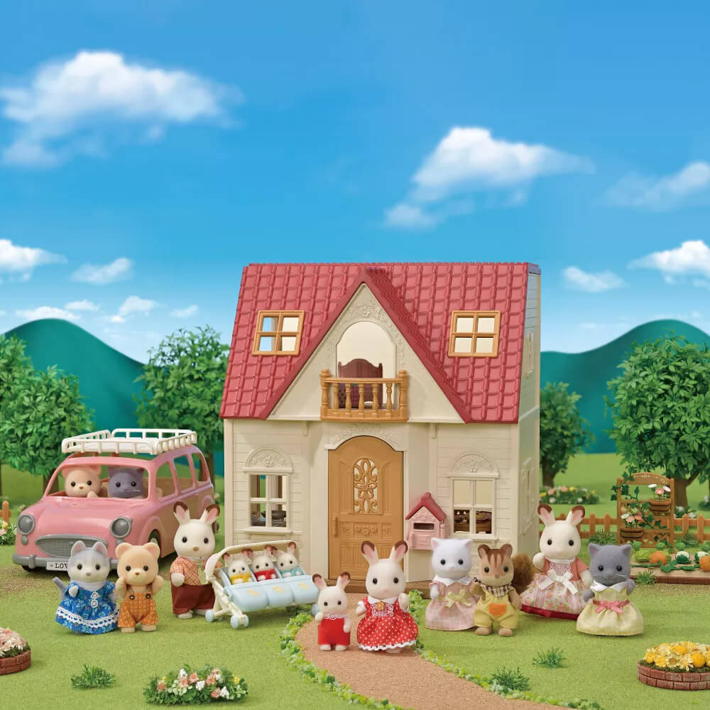 Calico Critters Red Roof Cozy Cottage Starter Home Playset with background and with dolls and car that are not included with this set