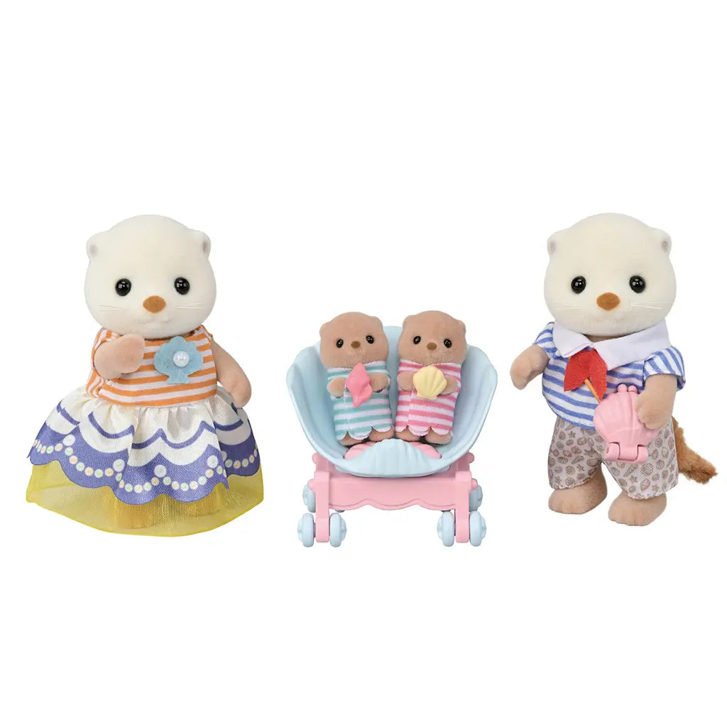 Calico Critters Sea Otter Family figures shown on white background with parents dressed in striped tops and patterned bottoms, and twin babies in seashell stroller holding pastel shell toys.