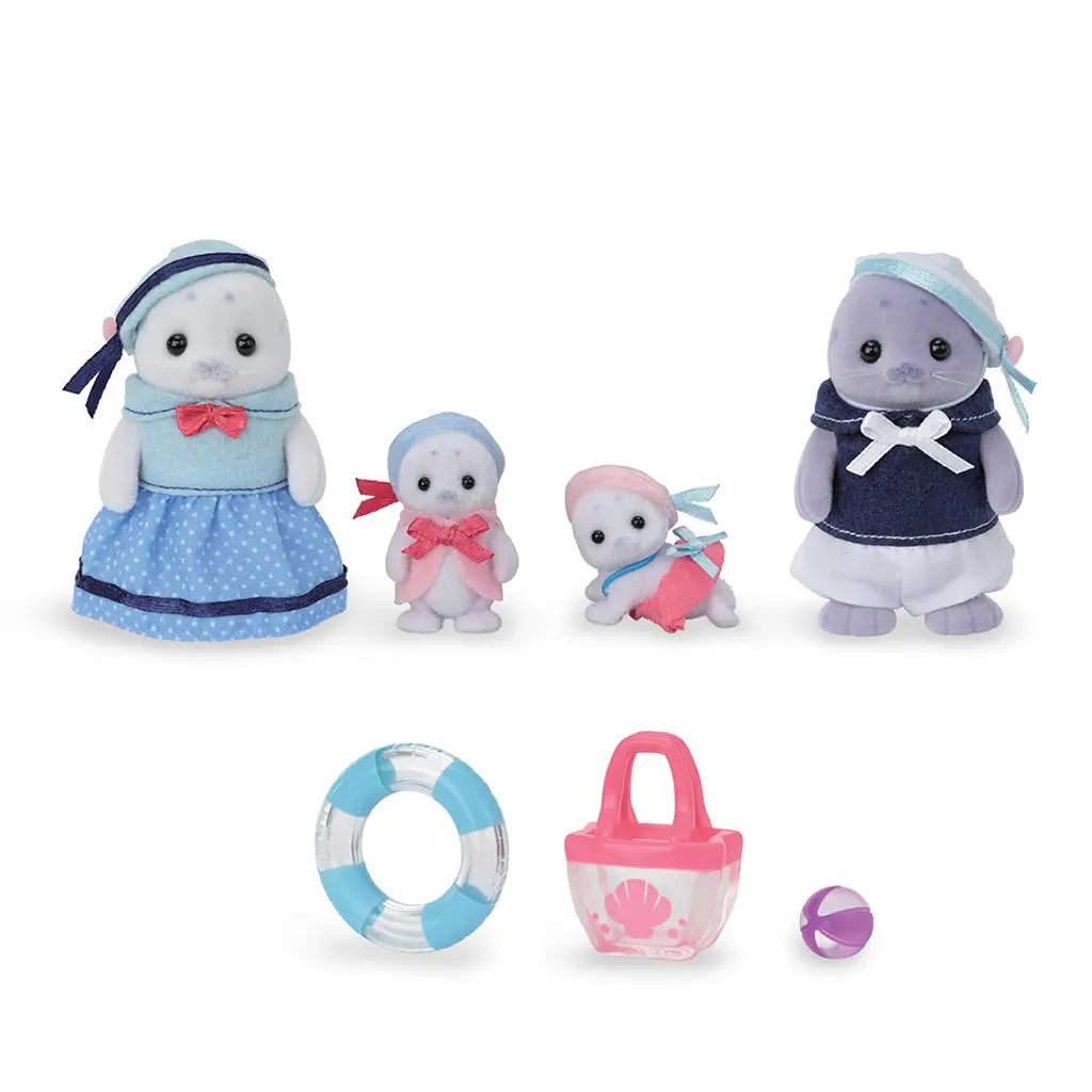 Calico Critters Seal Family toy set arranged on white background, including four seal figures with blue and pink outfits, plus accessories like a tote bag, float ring, and ball.