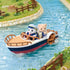 Calico Critters Seal Sailor's Leisure Boat scene shows a navy, white, and red paddle boat carrying two figures through turquoise water beside grassy, fenced riverbanks.