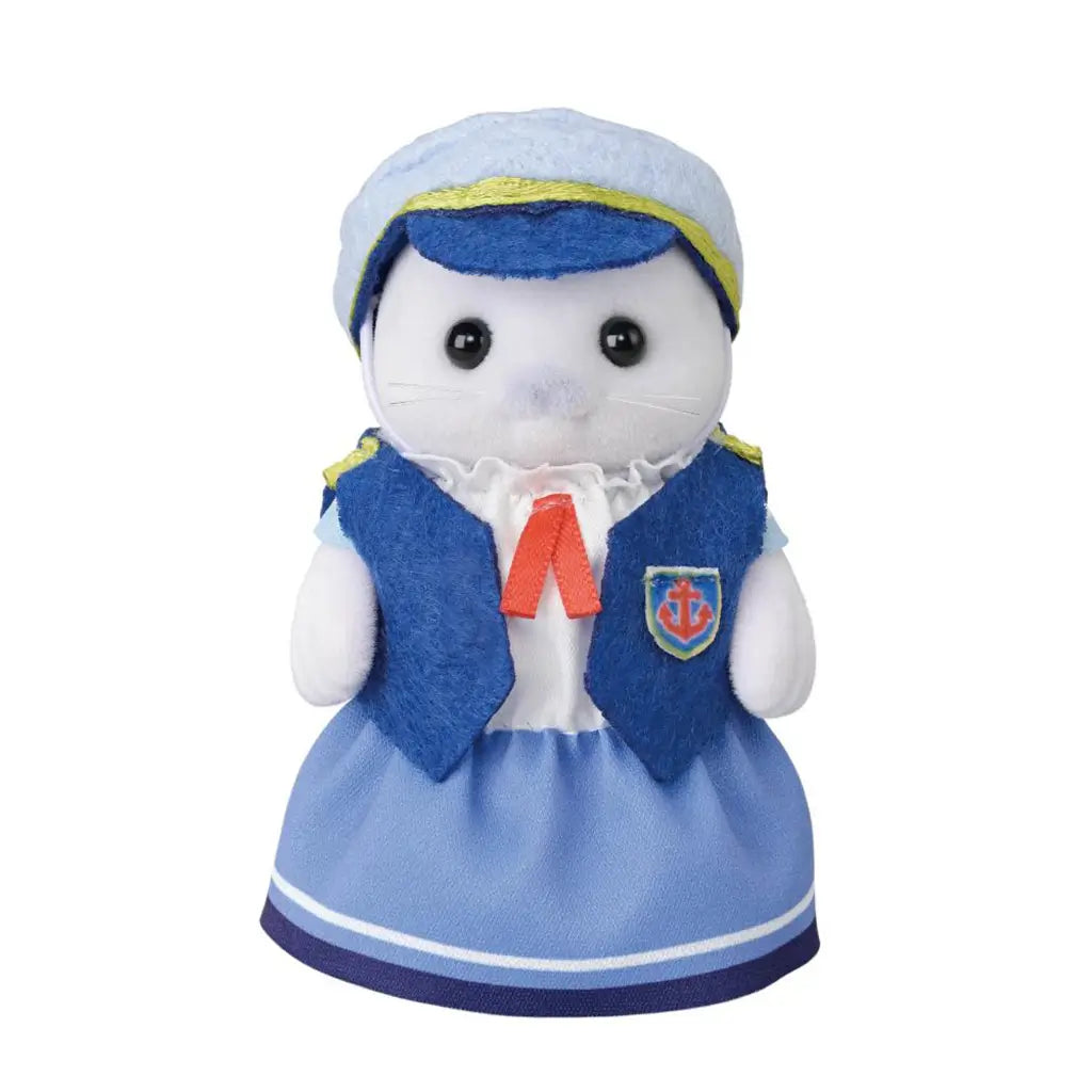 Calico Critters Seal Mother Amora figure has white flocked fur, a blue sailor vest and skirt, pale blue cap with yellow trim, red necktie, and anchor badge on white.