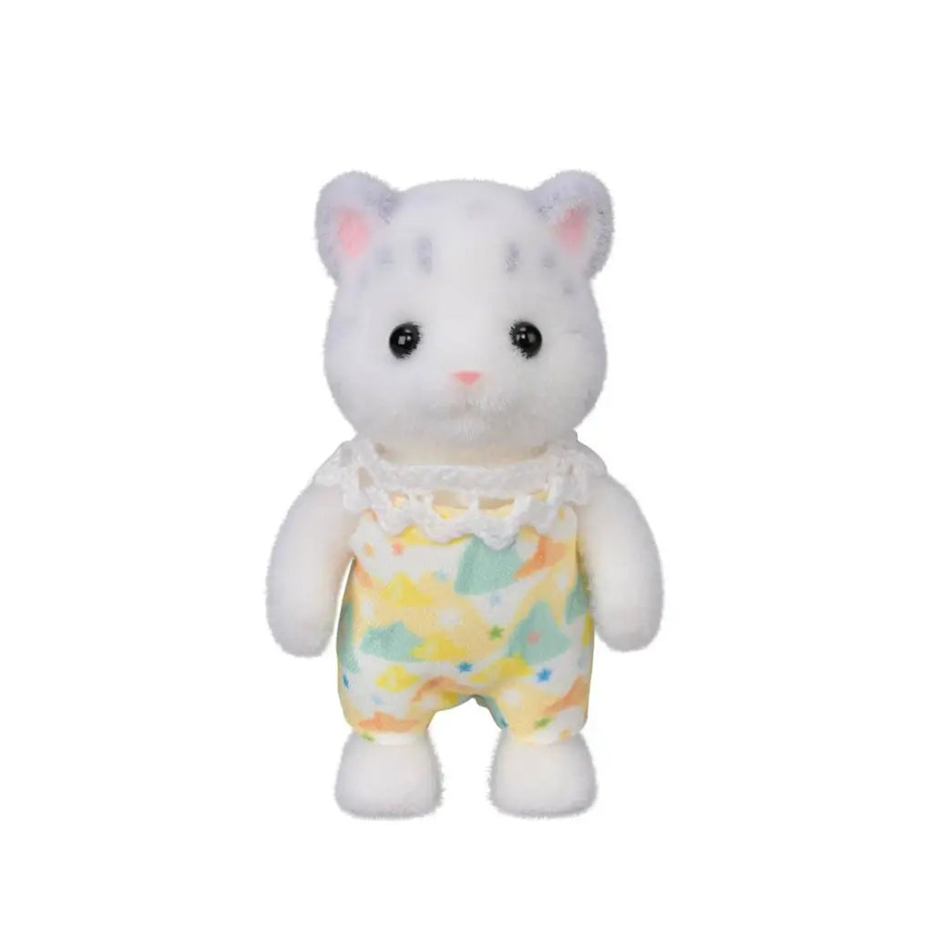Calico Critters Snow Leopard child figure has white flocked fur with gray spots and pink ears, wearing a colorful pastel romper with a white lace collar on white.