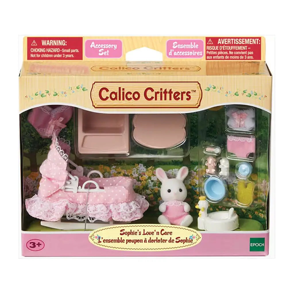 Calico Critters Sophie’s Love ’n Care accessory set package displays baby rabbit, pink stroller with lace trim, toy bathtub, feeding table, bottles, and small nursery accessories.