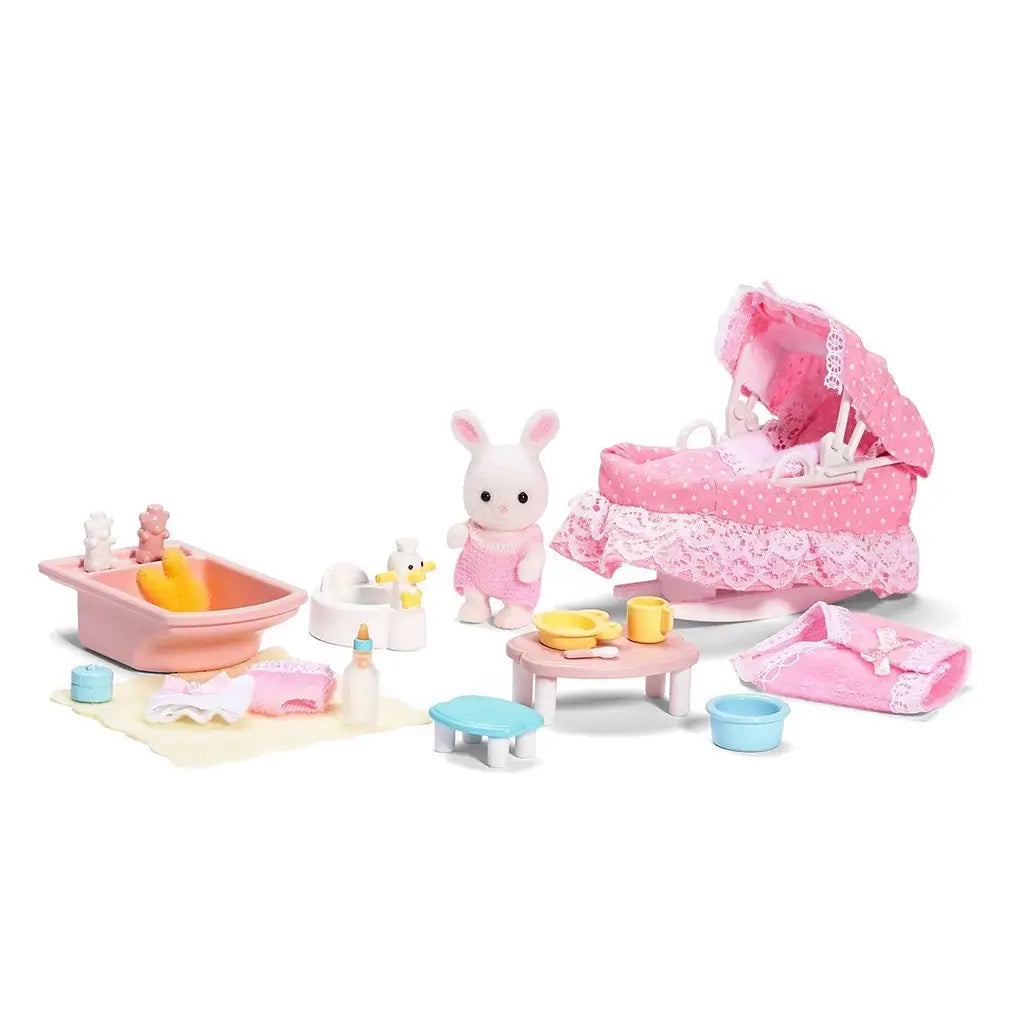 Calico Critters Sophie’s Love ’n Care set includes baby rabbit figurine, pink polka-dot stroller with lace trim, toy bathtub, feeding table, bottles, potty, and miniature nursery items.