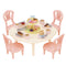 Calico Critters Sweets Party Set with pastel round table, four pink chairs, plates, forks, and desserts including cupcakes, eclairs, and tiered treat stand.