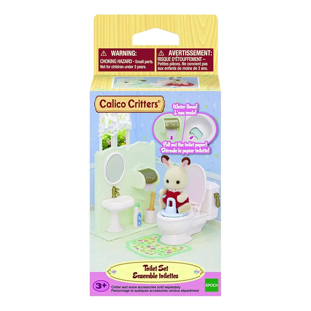 Calico Critters Toilet Set package front showing miniature white toilet, sink, floral rug, and rabbit figure in red outfit with text highlighting flush and paper roll features.