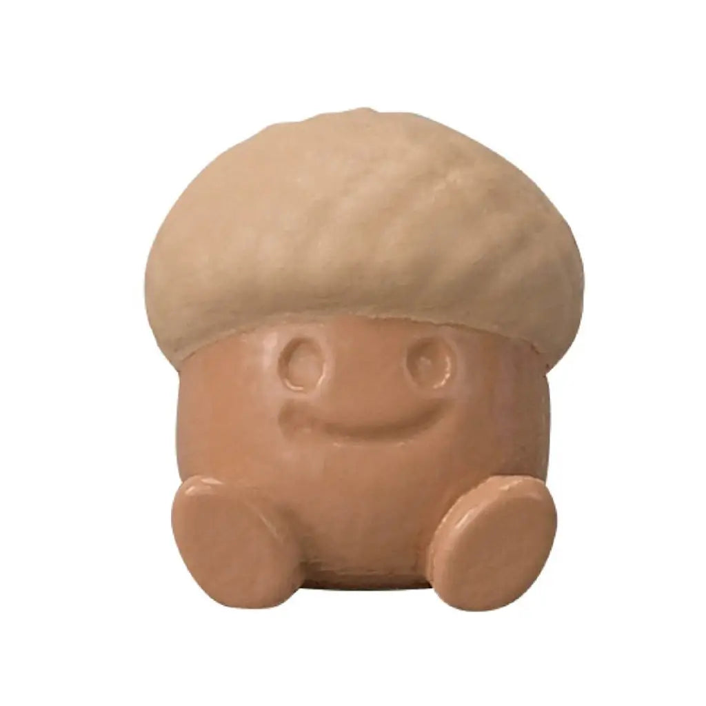 Calico Critters Woodland Wonder accessory is a tan molded acorn character with a rounded textured cap, smiling face, and oval feet, shown alone on a white background.