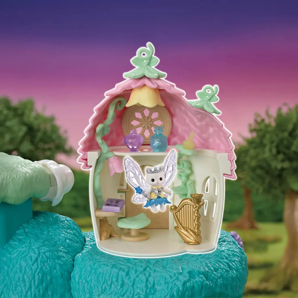 Calico Critters fairy castle room has a white shell, pink shingled roof, mint vine details, tiny potion bottles, harp, stool, book, and a winged cat fairy inside.