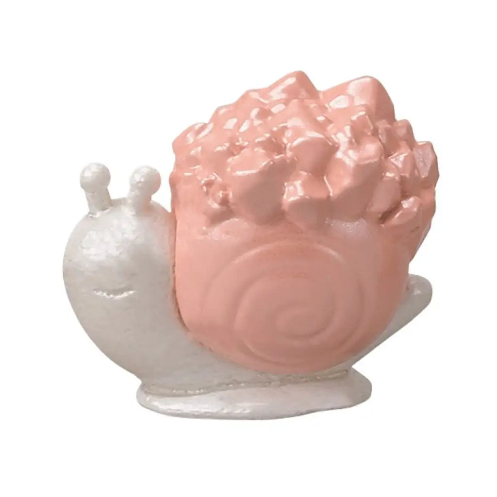 Calico Critters Woodland Wonder snail friend is a pearly white molded snail with a smiling face and antennae, carrying a glossy pink shell topped with crystal-like rocks.