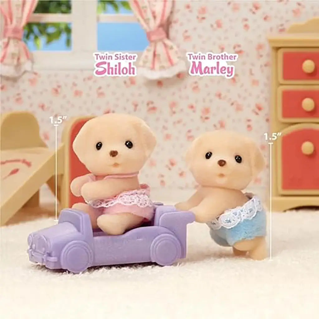 Calico Critters Yellow Labrador twin figures named Shiloh and Marley, each 1.5 inches tall, posed with a lavender toy car inside a floral-themed dollhouse bedroom set.