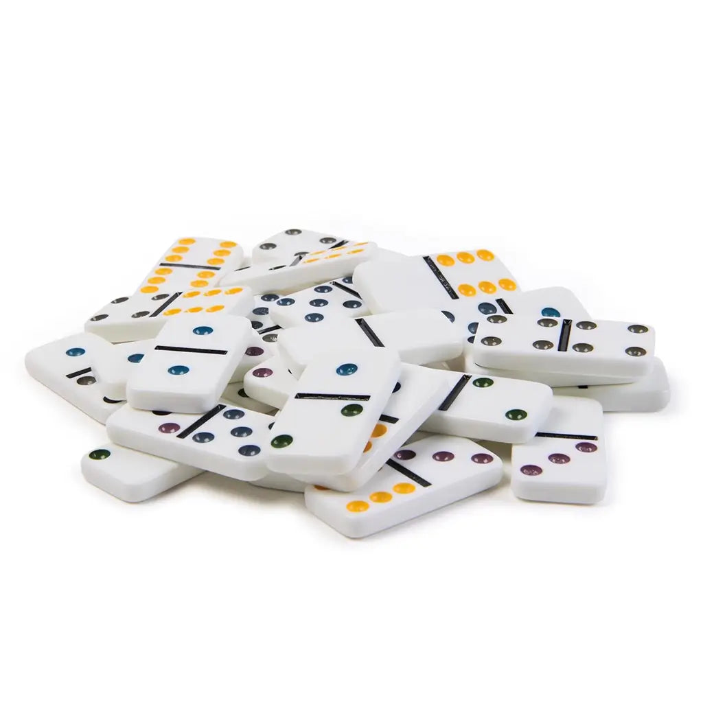 Pile of glossy white domino tiles scattered loosely, each marked with multicolored pips in yellow, blue, purple, green, and gray, highlighting their durable plastic construction.