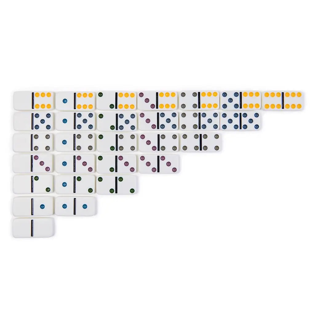 White domino tiles arranged in a star-like layout with a gray centerpiece, showing the Cardinal Classics Double-Six Dominoes used in play with colorful recessed dots on each tile.