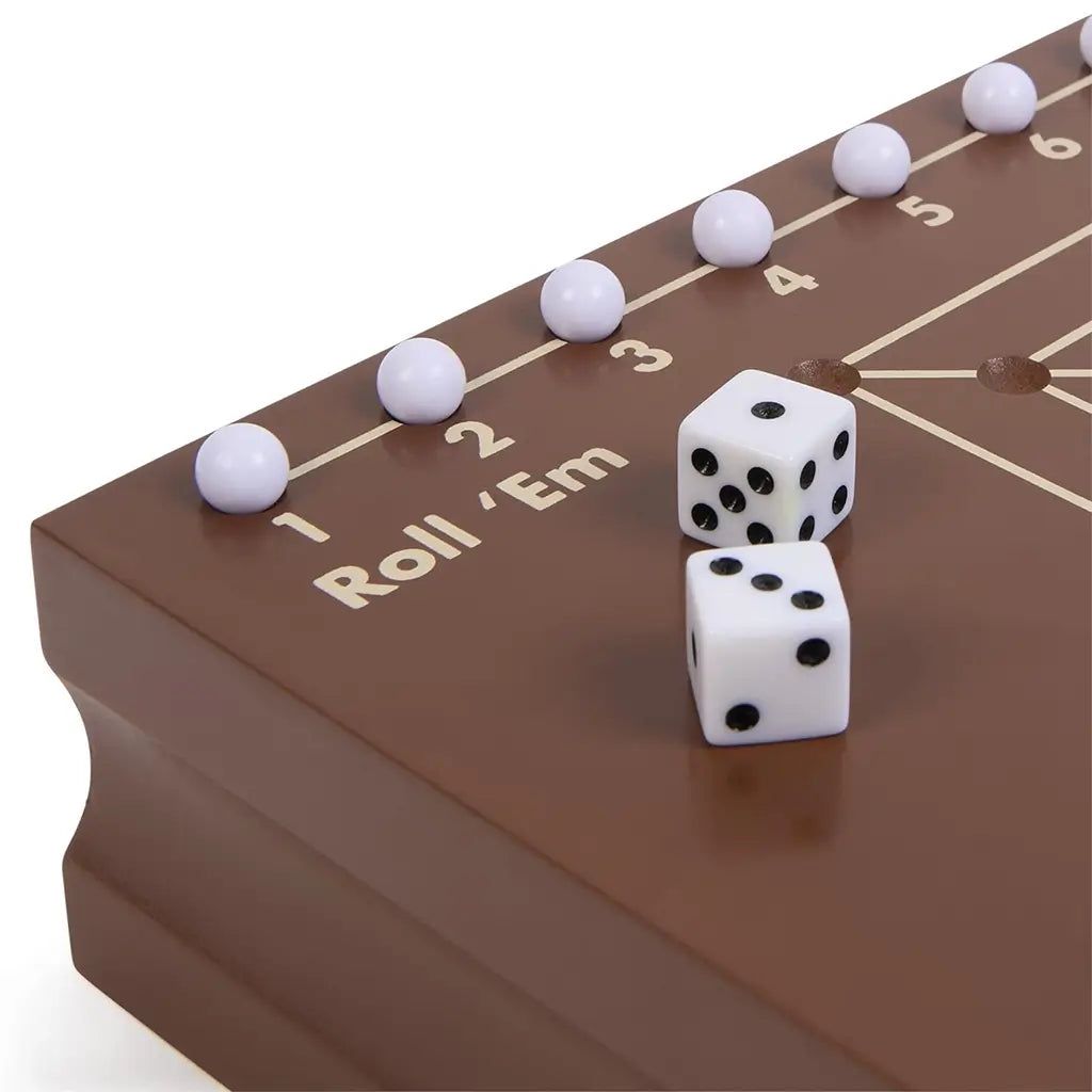 Cardinal Classics Roll Em dice game on a polished brown wooden board with numbered track and smooth white pegs, featuring two white dice for interactive family tabletop play.