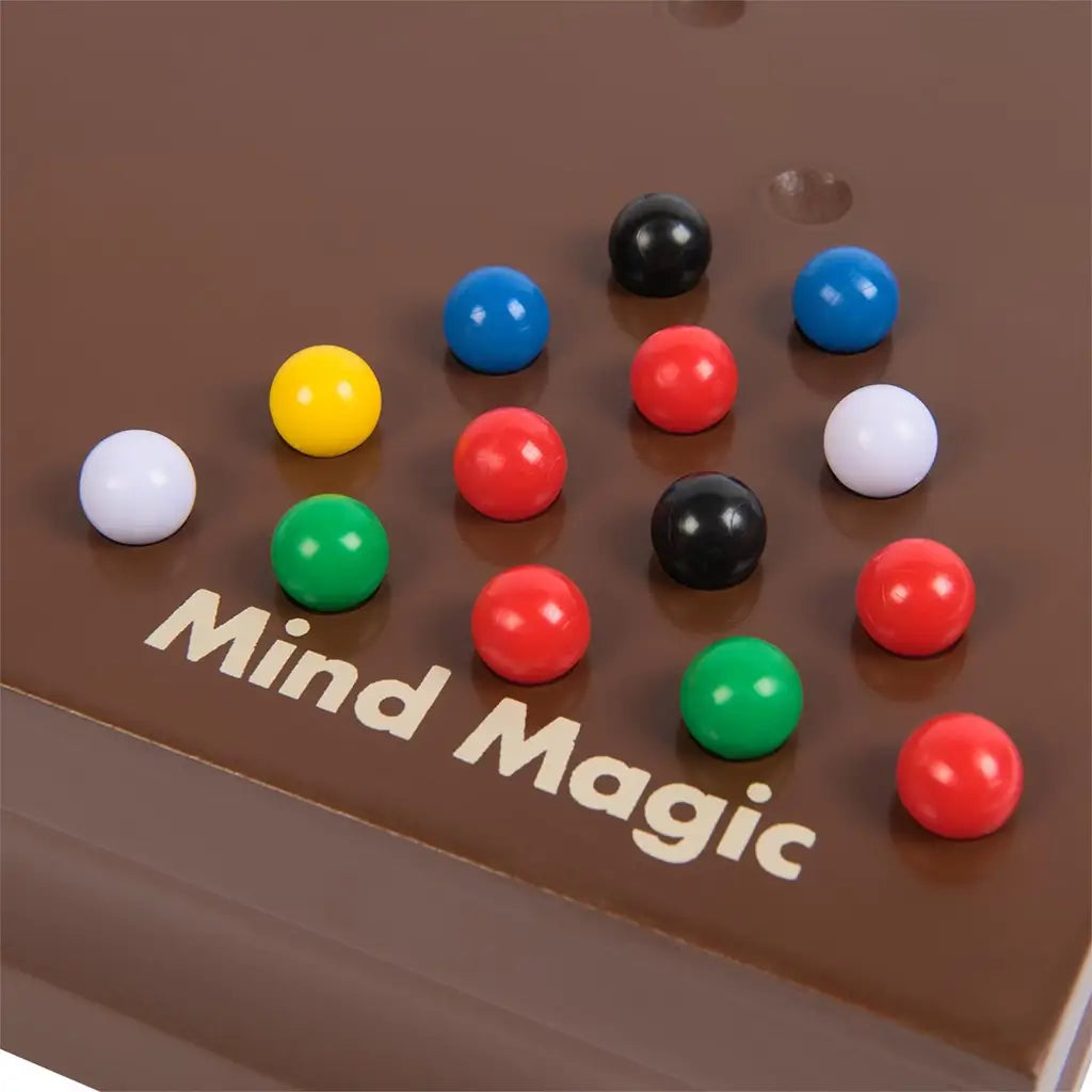 Cardinal Classics Mind Magic board in rich brown wood with glossy red, blue, green, yellow, black and white marbles arranged in a grid pattern for strategic tabletop puzzle play.