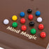 Cardinal Classics Mind Magic board in rich brown wood with glossy red, blue, green, yellow, black and white marbles arranged in a grid pattern for strategic tabletop puzzle play.