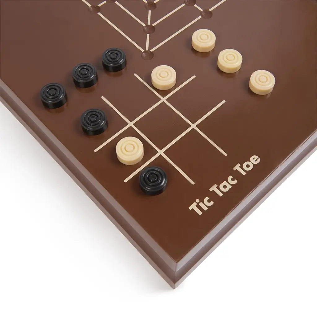 Cardinal Classics Tic Tac Toe board in smooth brown wood with black and natural round checkers placed on a white grid, designed for classic strategy gameplay on a tabletop surface.