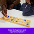 Two players seated at a table playing Mancala with colorful glass stones on a light wooden board, captioned as great for both beginners and experienced players.