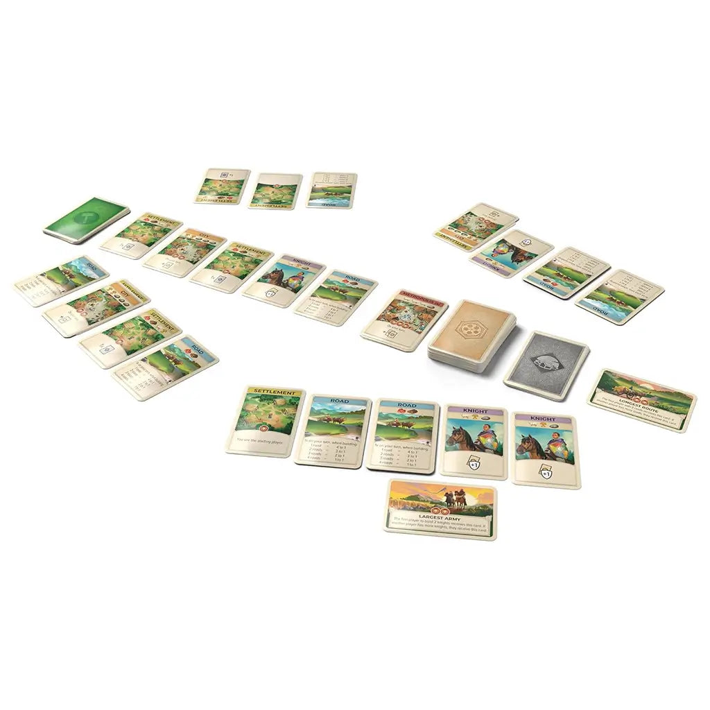 CATAN On the Road 120-card set displays illustrated settlement, road, knight, resource, and bonus cards in organized groups with three card decks on a white background.