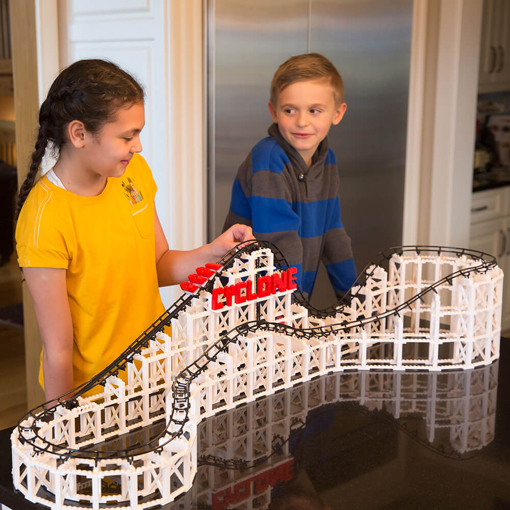 Boy and girl playing with the CDX Blocks The Cyclone Roller Coaster 900 Piece Building Kit