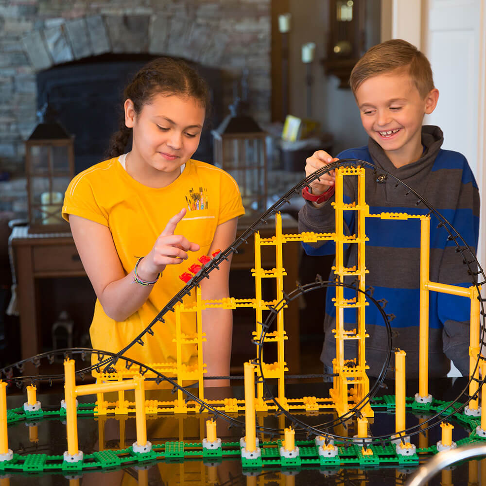 Boy and girl playing with the CDX Blocks The Sidewinder Roller Coaster 825 Piece Building Kit on a table.