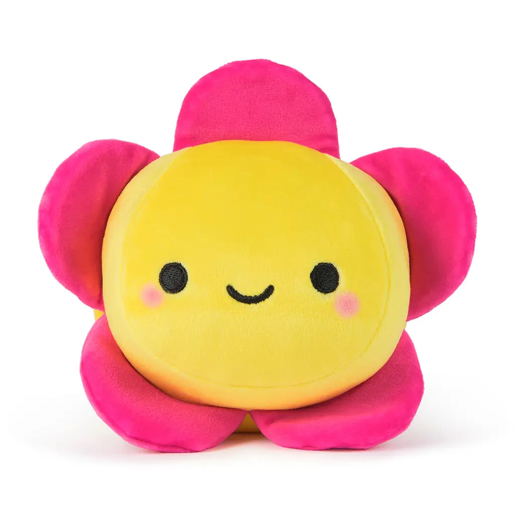 Front-facing 6-inch plush flower toy with a soft yellow center, embroidered smile, and bright pink petals, offering a cheerful and cuddly reversible design.