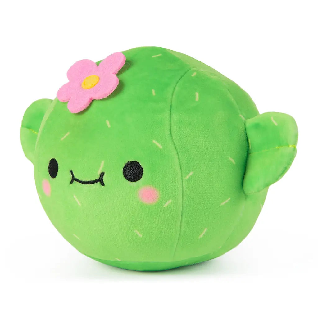Angled front view of Prickly Pants plush from Cheeky Chonks, with a cute embroidered smile, pink cheeks, and soft green cactus design with a pink felt flower.